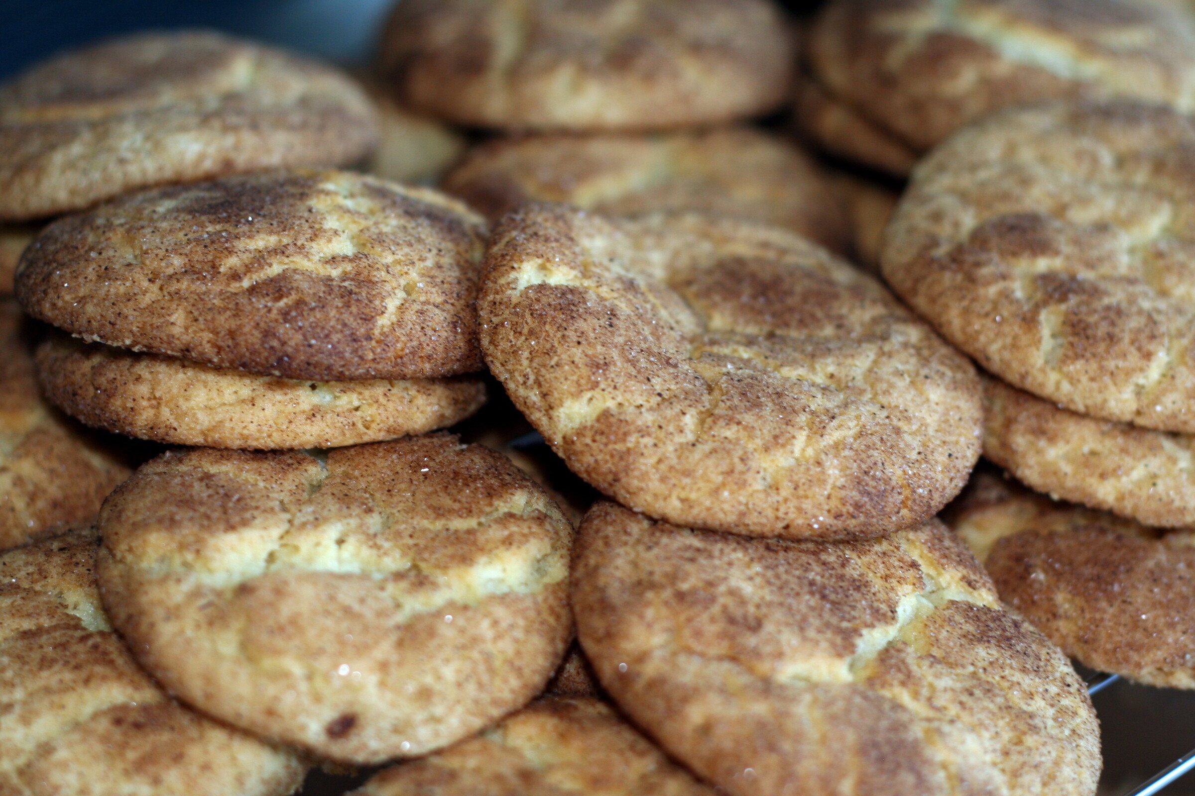A pile of cinnamon sugar snickerdoodle cookies with crinkled tops